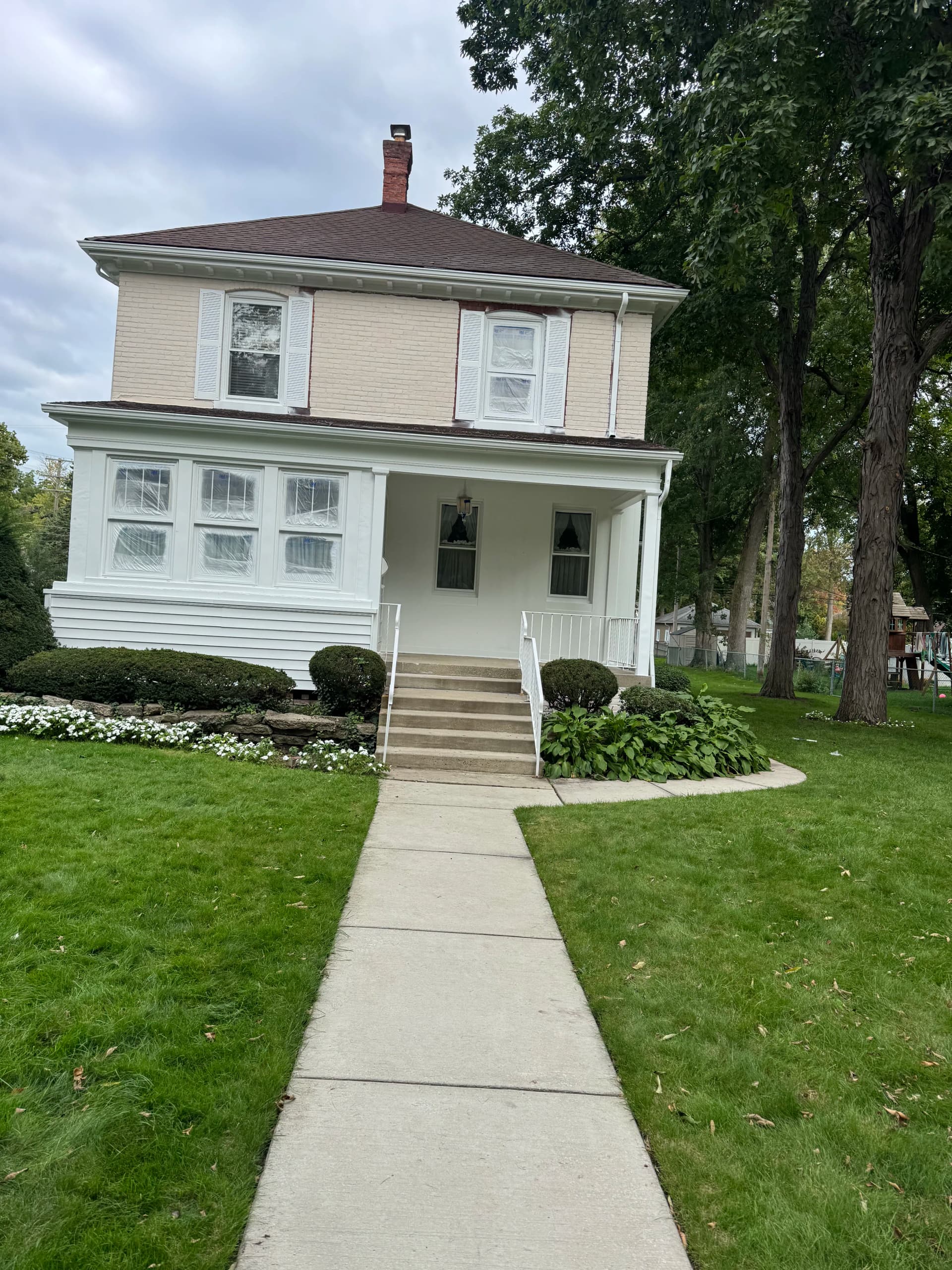 Gallery photos for Painted Brick Exterior Before and After on a Classic Two-Story Home: Image #1